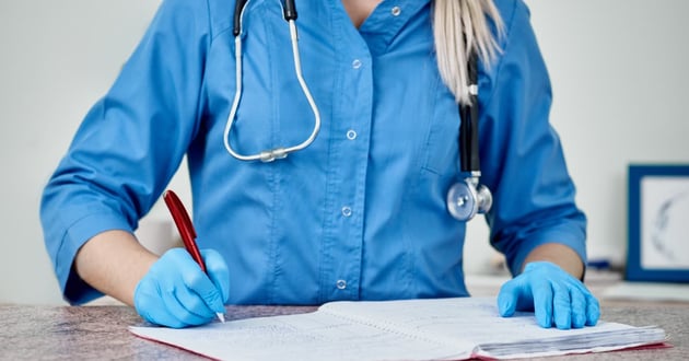 Veterinarian doing charting work following a procedure