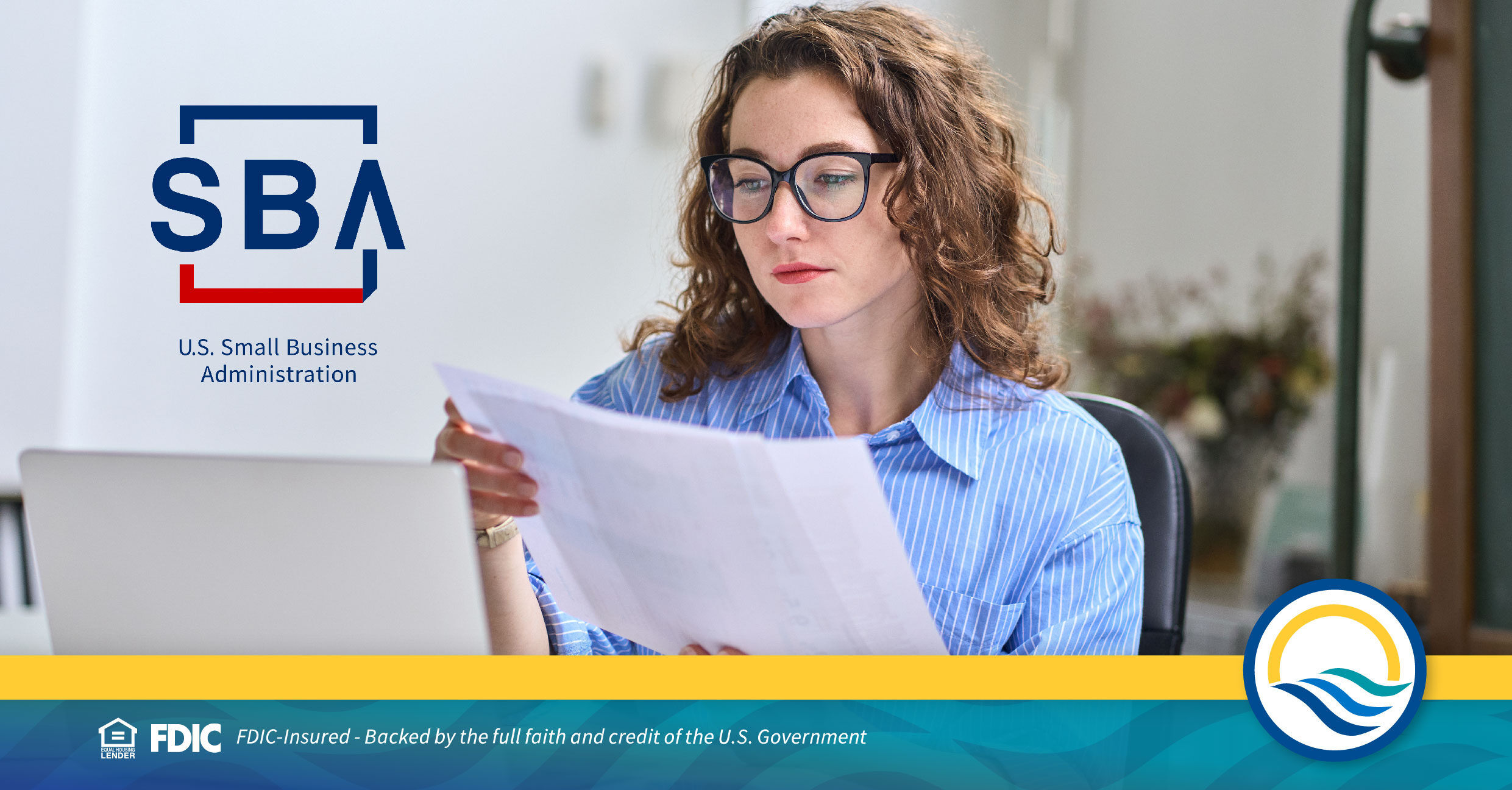 Woman reviews documents at a desk with SBA logo